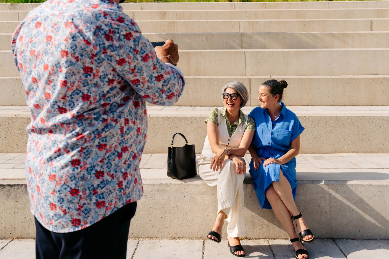 women getting photograph taken outside